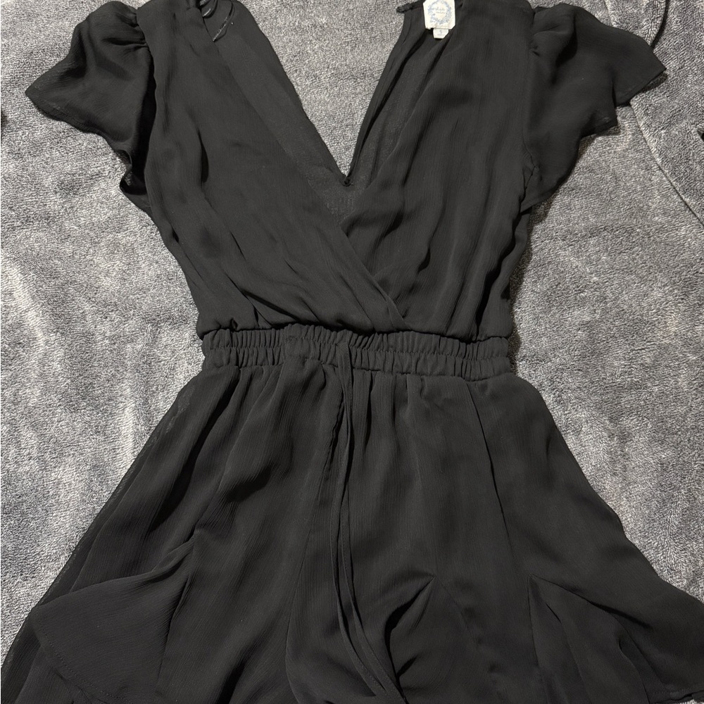 Black romper, size small. The back is sheer as well as the sleeves!